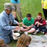 Mary showing deer skeleton to kids.